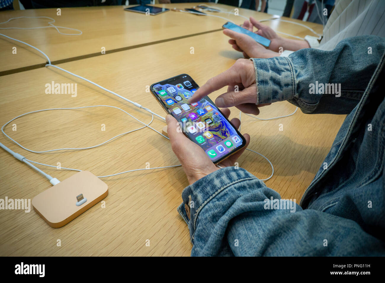 New York, USA. 21st September 2018. Customers in the Apple store in the WTC Transportation Hub in New York try out the new iPhone XS on Friday, September 21, 2018, the first day they went on sale.  The new phones, anxiously awaited by drooling iPhone aficionados, sell for a whopping $999 for the XS and $1099 for the XS Max with the Max having a 6.5 inch display.  (Â© Richard B. Levine) Credit: Richard Levine/Alamy Live News Credit: Richard Levine/Alamy Live News Stock Photo