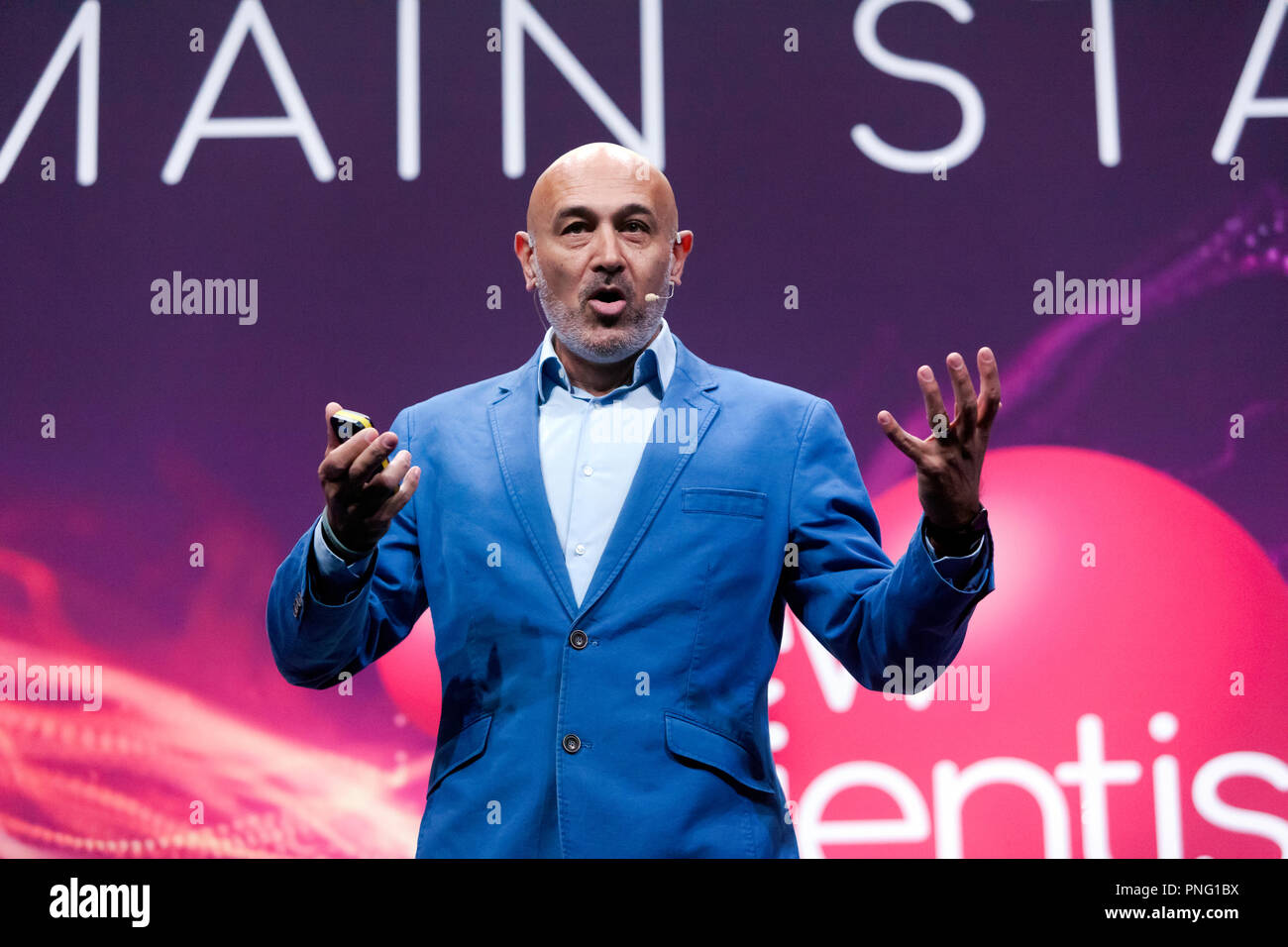 Physicist and broadcaster, Jim Al-Khalili, giving a bief history of Gravity, how it shapes the Cosmos but how we dont completely understand it. on the main Stage, at New Scientist Live Stock Photo