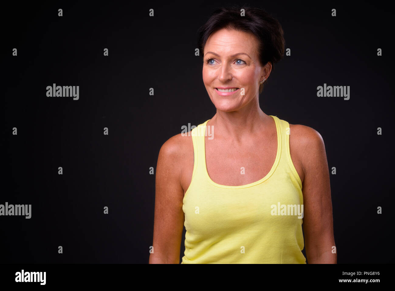 Mature Beautiful Woman With Short Hair Against Black Background