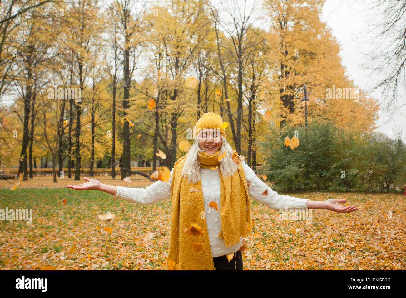 Girl walking in fall park on autumn background Stock Photo - Alamy