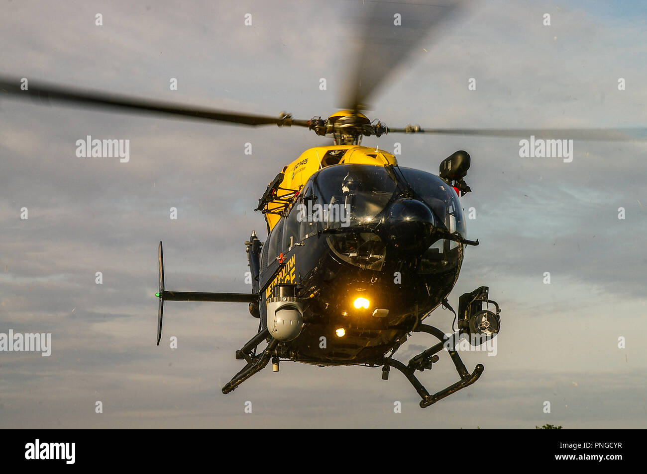 Police helicopter G-MPSC Eurocopter EC145 landing. Hovering. Eye in the sky. Searchlight. Space for copy Stock Photo