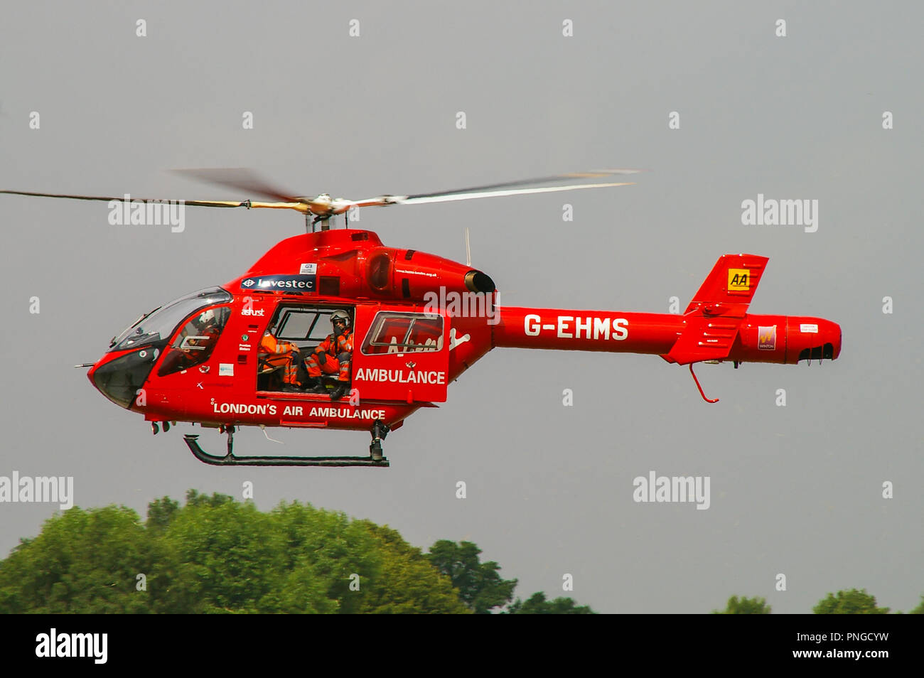 London Air Ambulance helicopter MD900 Explorer G-EHMS, sponsored by AA and Investec, flying. Crew, medics. London's Air Ambulance Stock Photo
