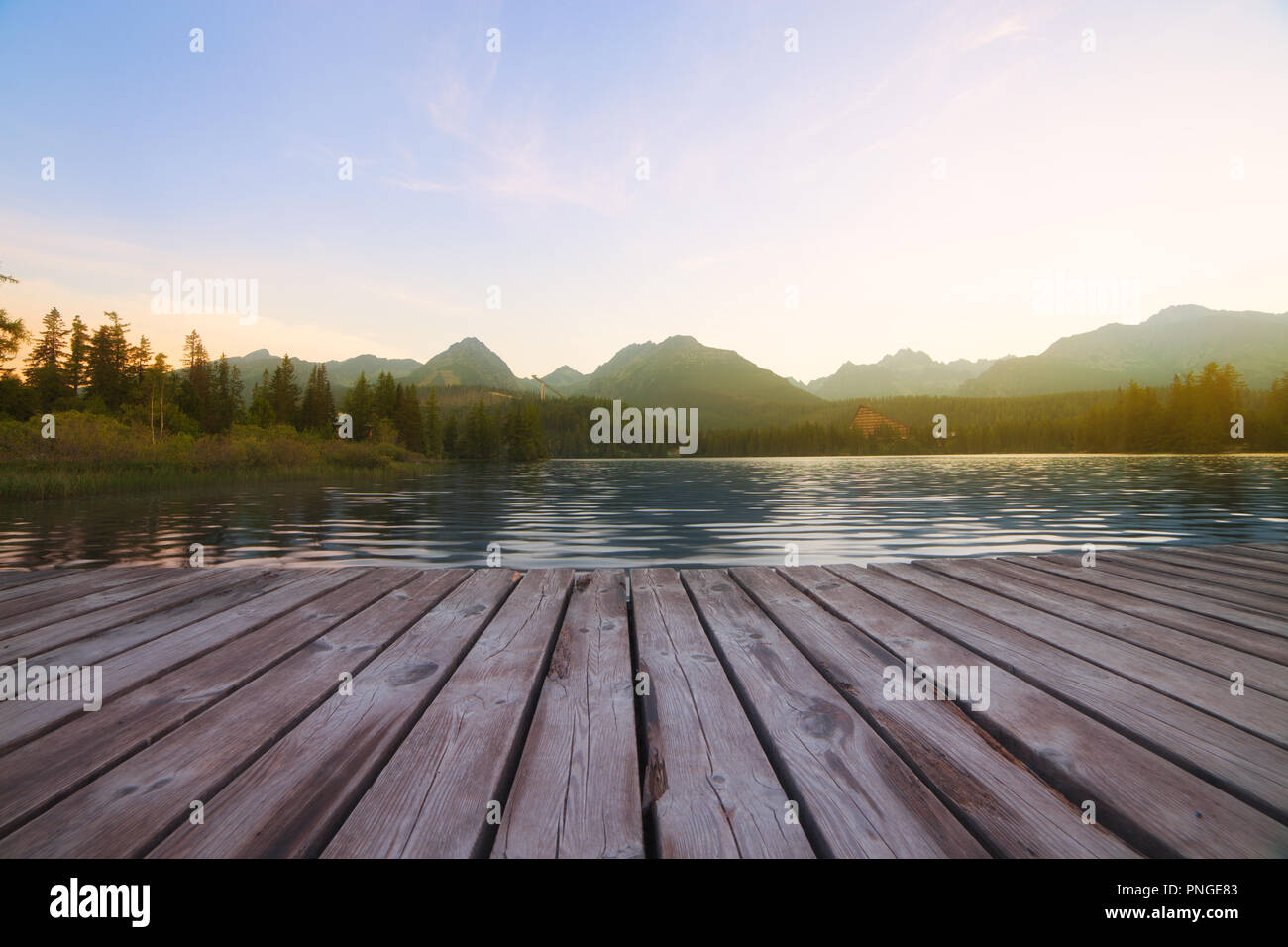 Forest Alpine mountain lake and wooden board background Stock Photo - Alamy