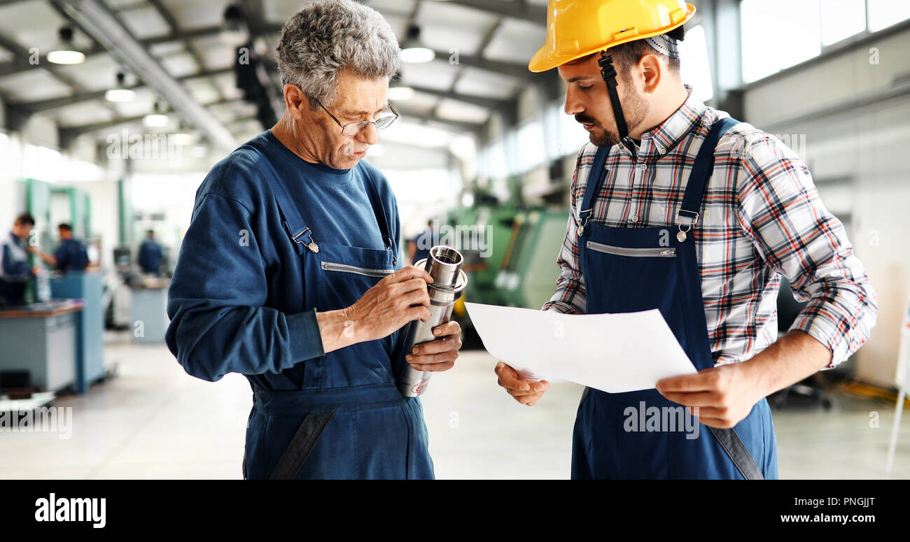 Supplier with engineer checking on production in factory Stock Photo