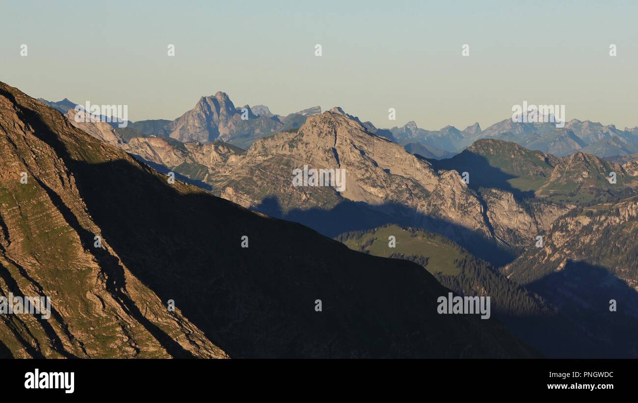 Mountain ranges in the Bernese Oberland at sunrise. Stunning view from Mount Niesen. Stock Photo
