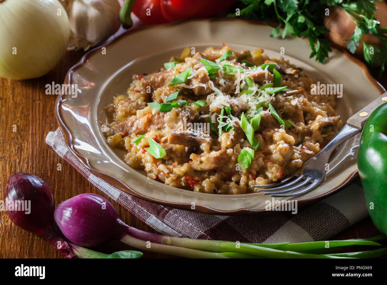 Risotto with champignon mushrooms, pork and parmesan. Italian cuisine Stock Photo