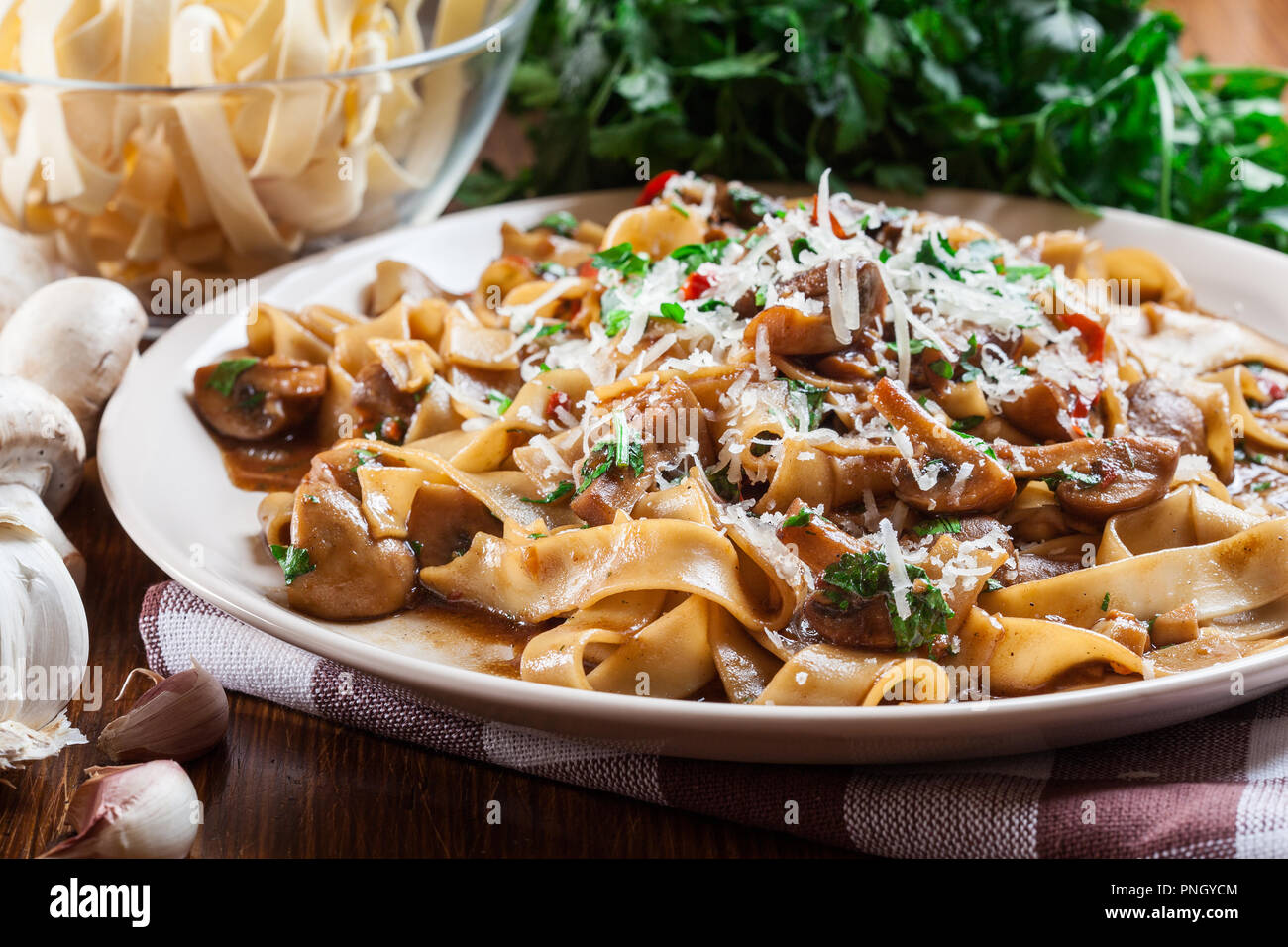 Tagliatelle pasta with champignon in mushroom gravy. Italian dish Stock Photo