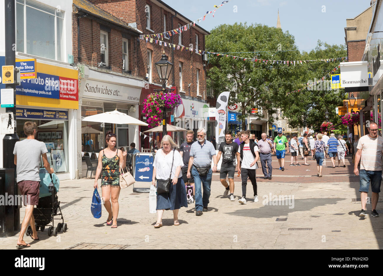 People shopping in pedestrianised High Street area, Poole, Dorset, England, UK Stock Photo