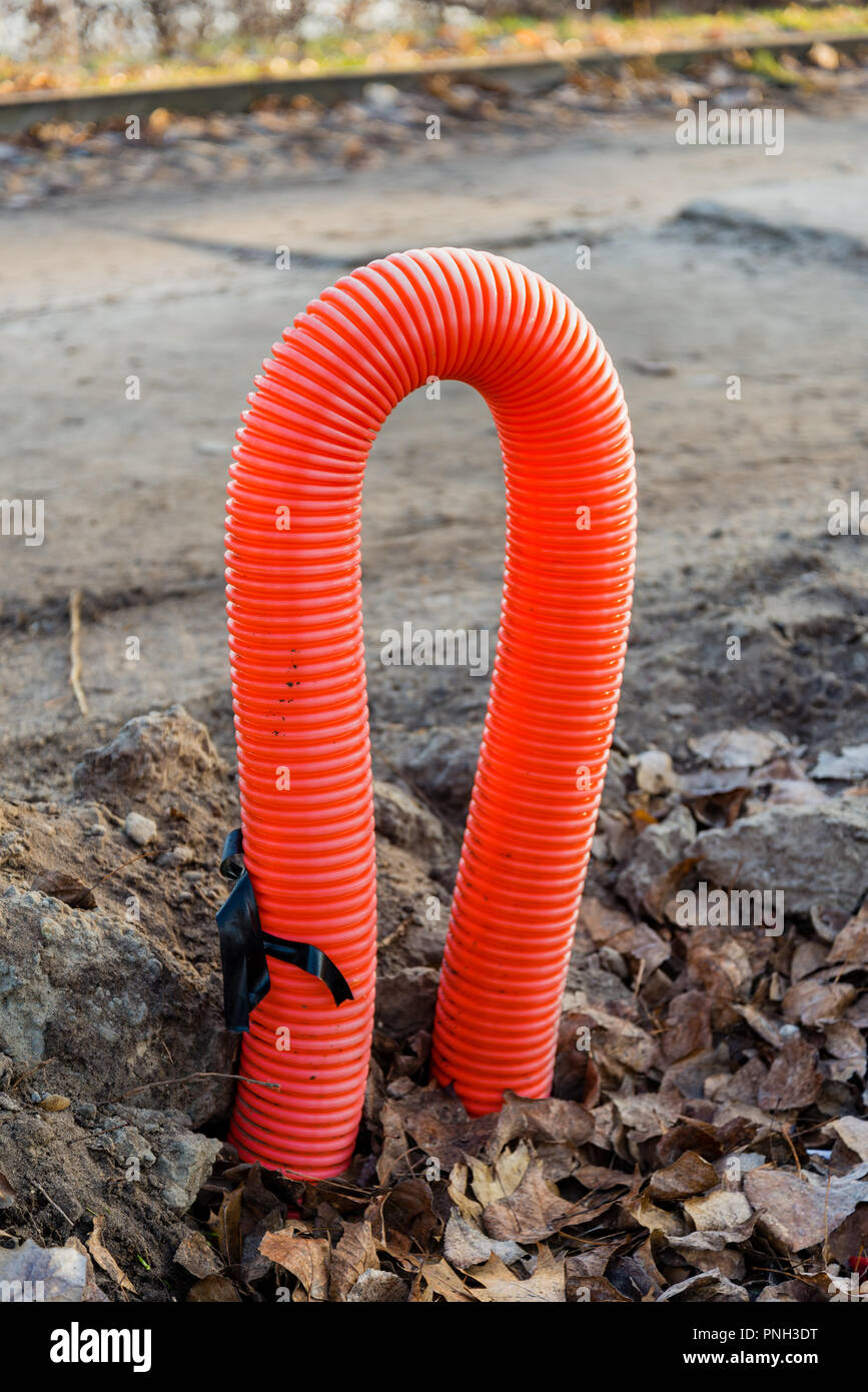 Red orange corrugated sheath for electric cables, on a building construction site Stock Photo