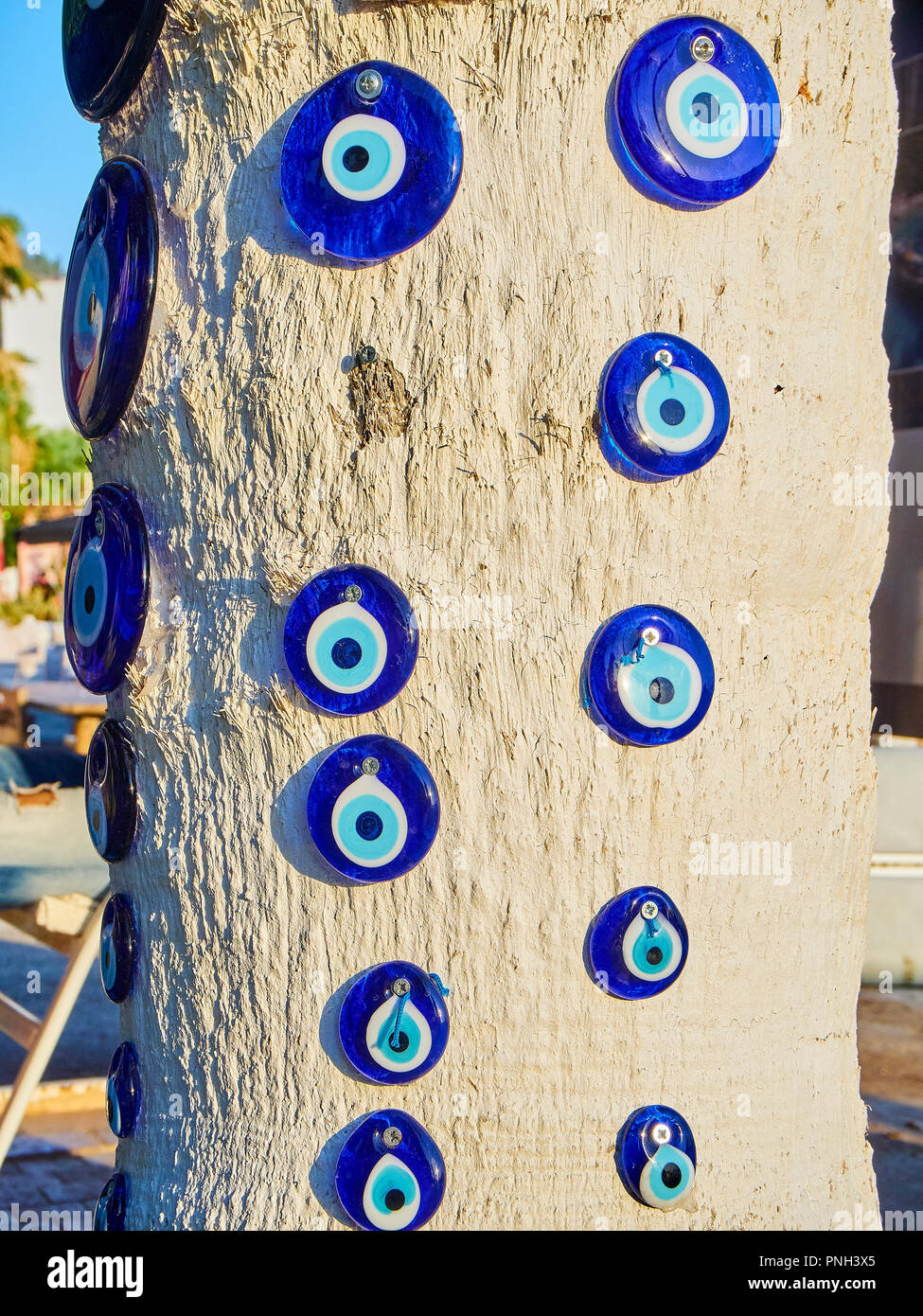 A lot of Nazar boncugu, a Turkish eye-shaped amulet screwed to a tree. Turkey. Stock Photo
