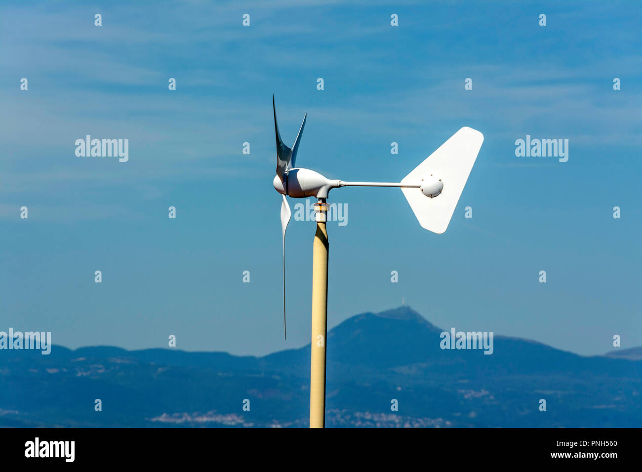 Micro wind turbine on the roof of a house, Puy de Dome department, Auvergne Rhone Alpes, France Stock Photo