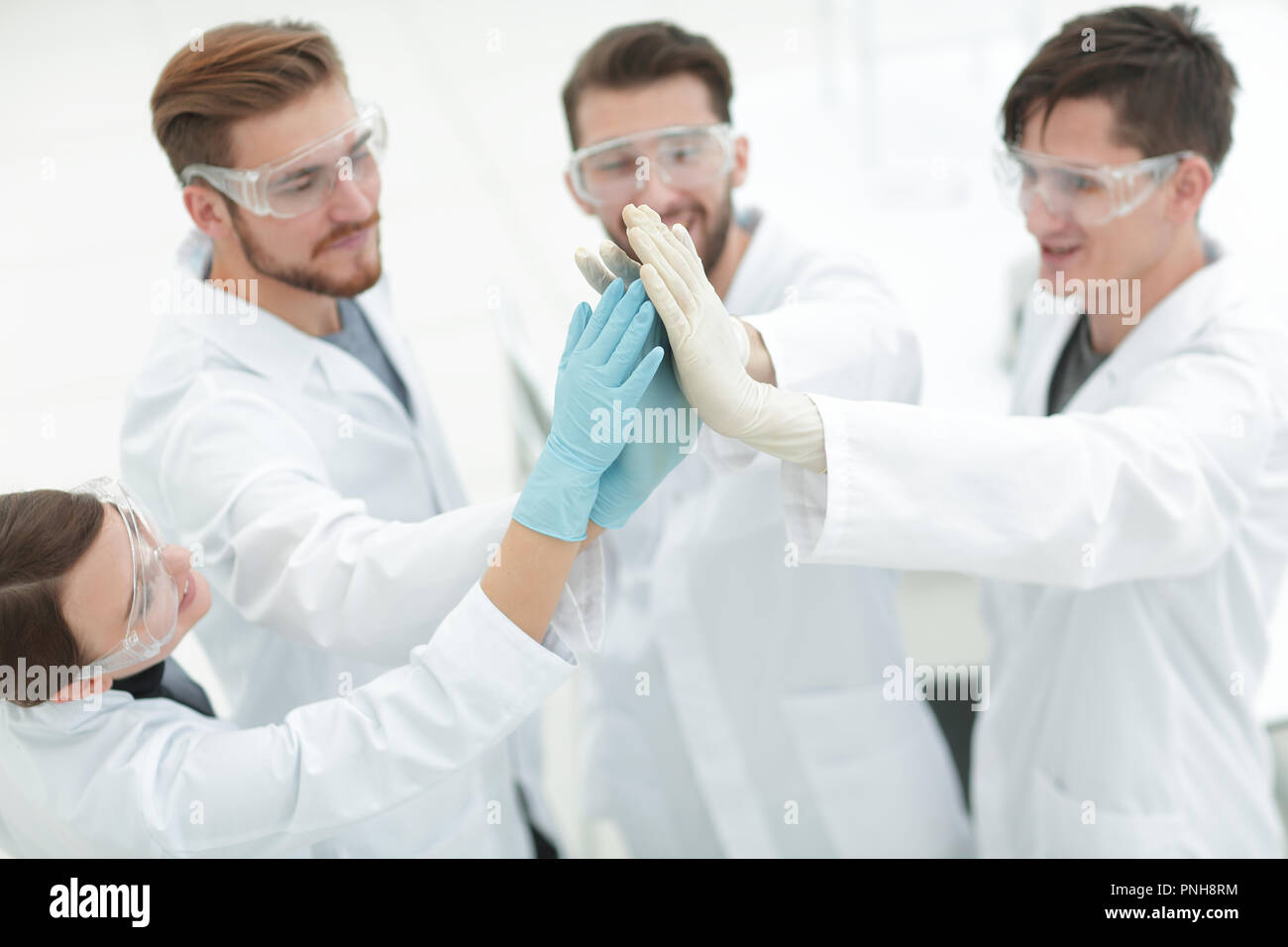 scientists giving each other a high five Stock Photo Alamy