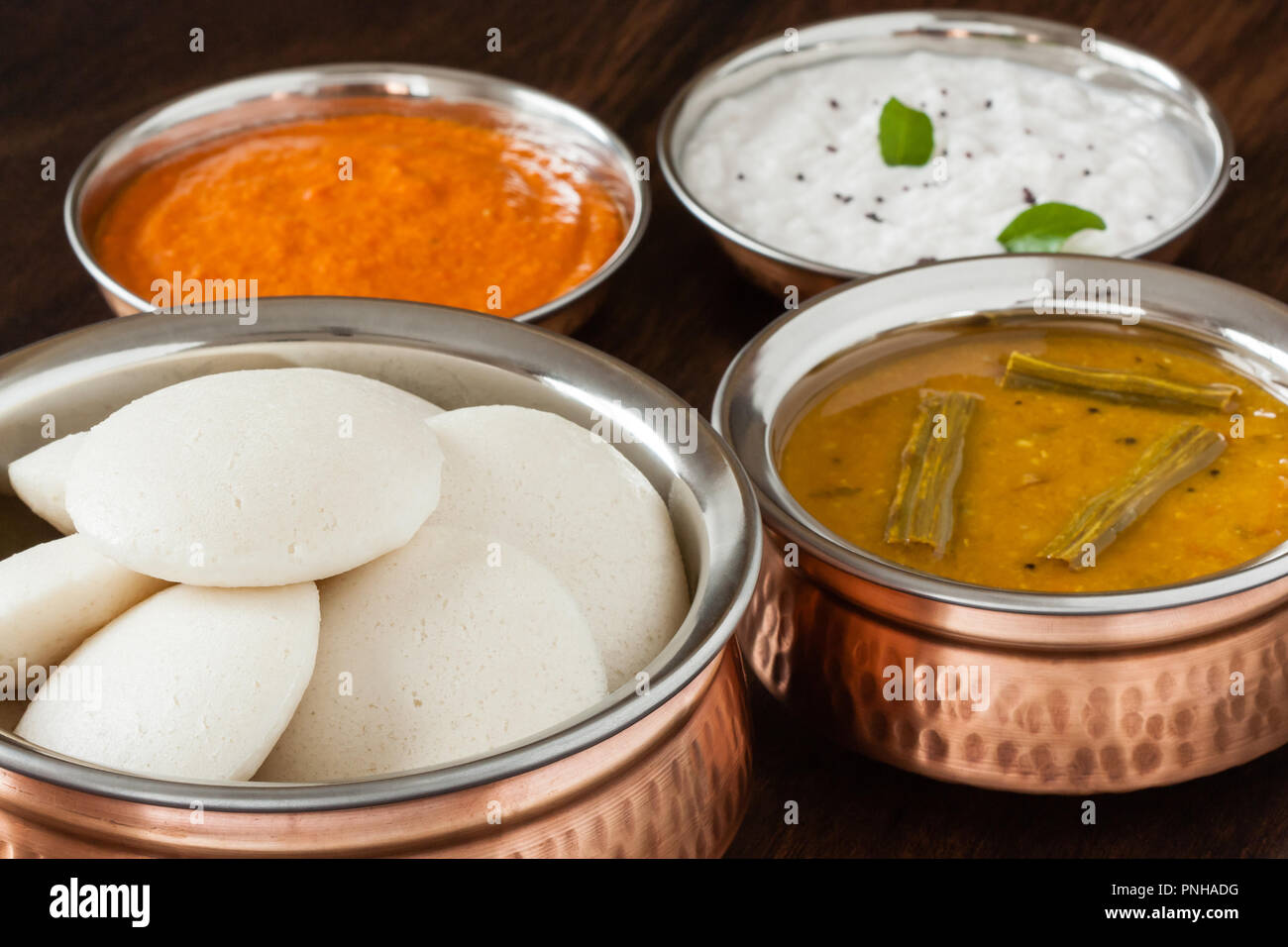 Fresh steamed Indian Idly (Idli / rice cake) arranged in authentic