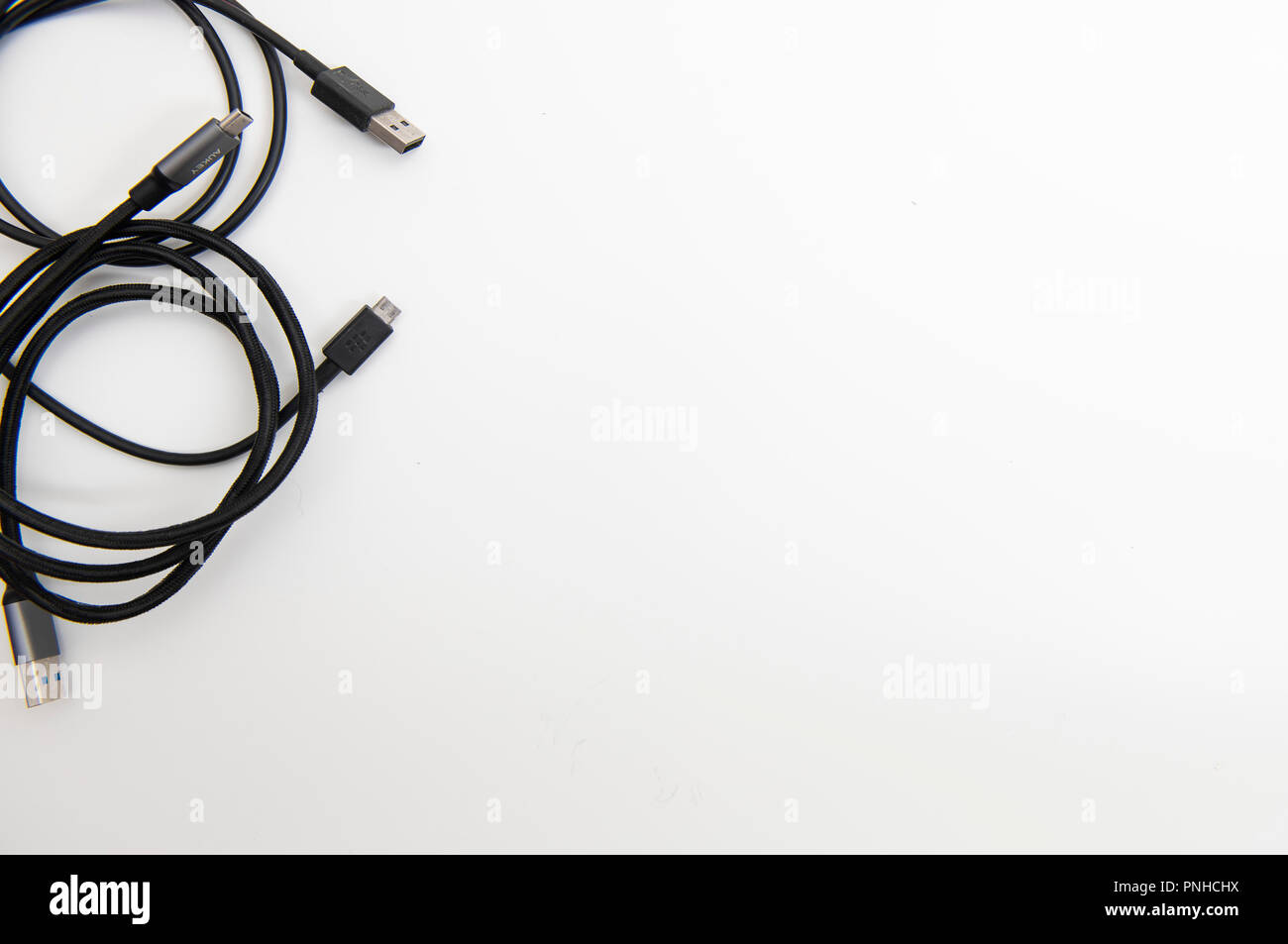 White desk with various USB cables. Stock Photo