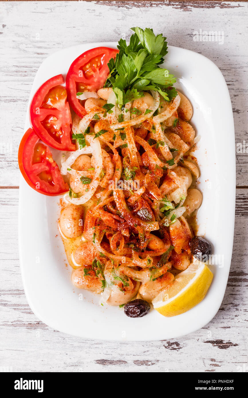 Traditional Turkish salad piyaz with onion, lemon, lettuce and pepper Stock Photo