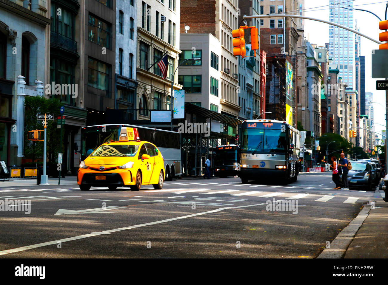 New York street scene with yellow taxi and people in Manhattan Stock Photo