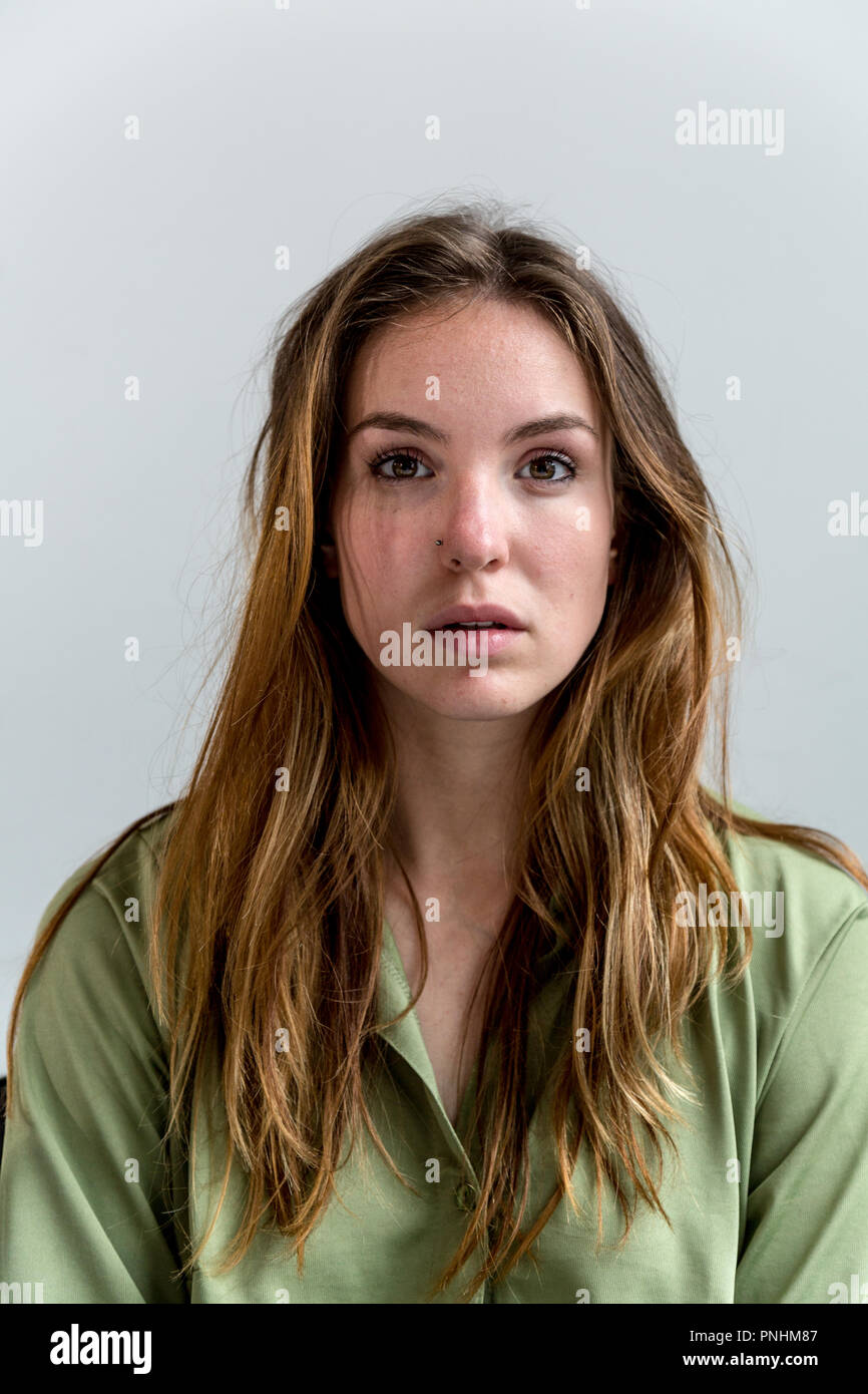 Portrait of a young woman looking towards the camera. Medium close up. Stock Photo