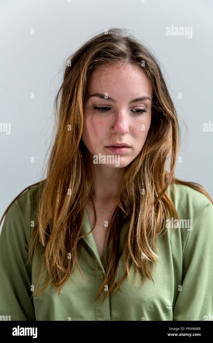 Portrait of a young woman looking downwards. Medium close up. Stock Photo