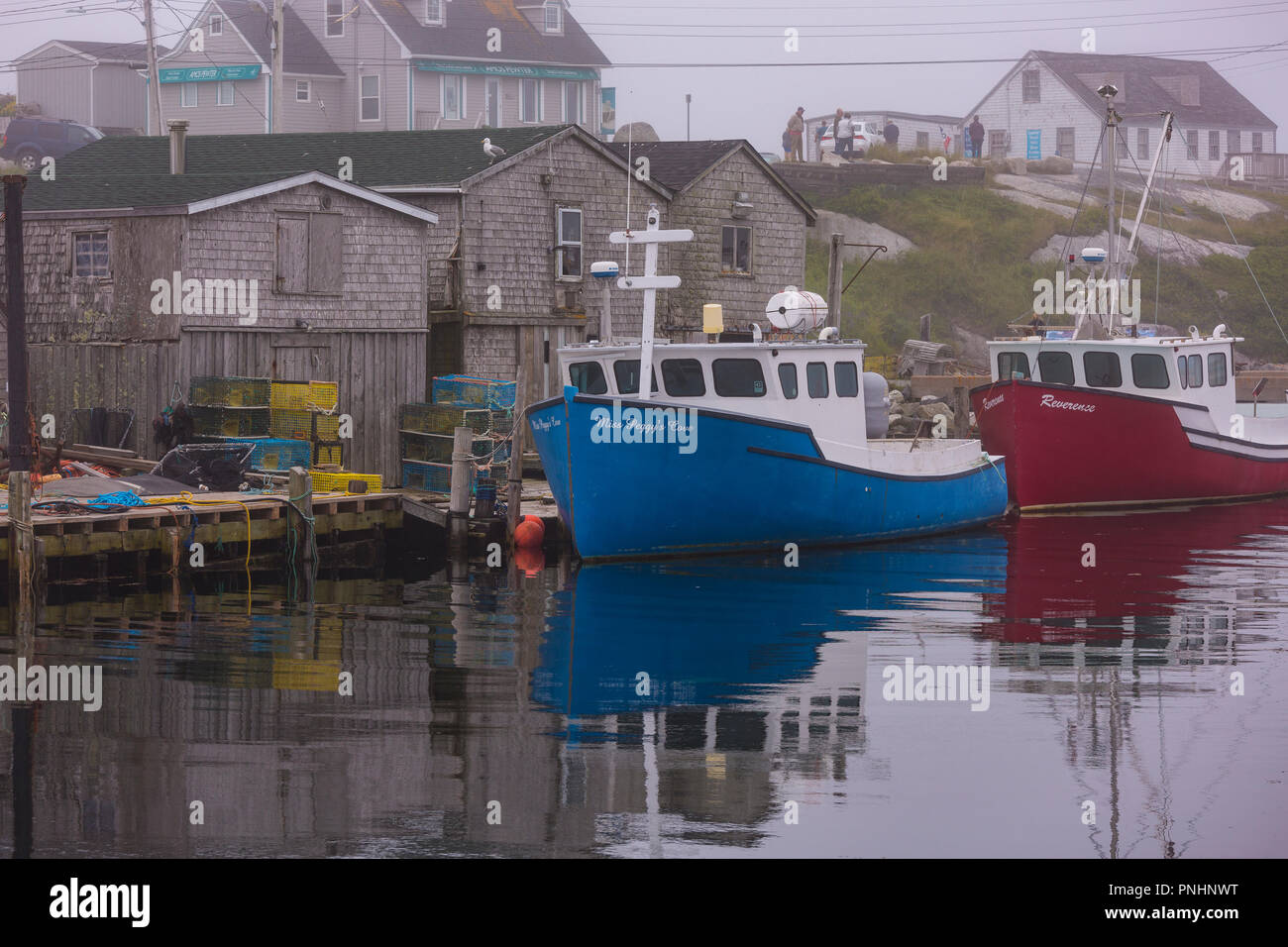 PEGGY'S COVE, NOVA SCOTIA, CANADA - Boats docked in fishing village harbor. Stock Photo
