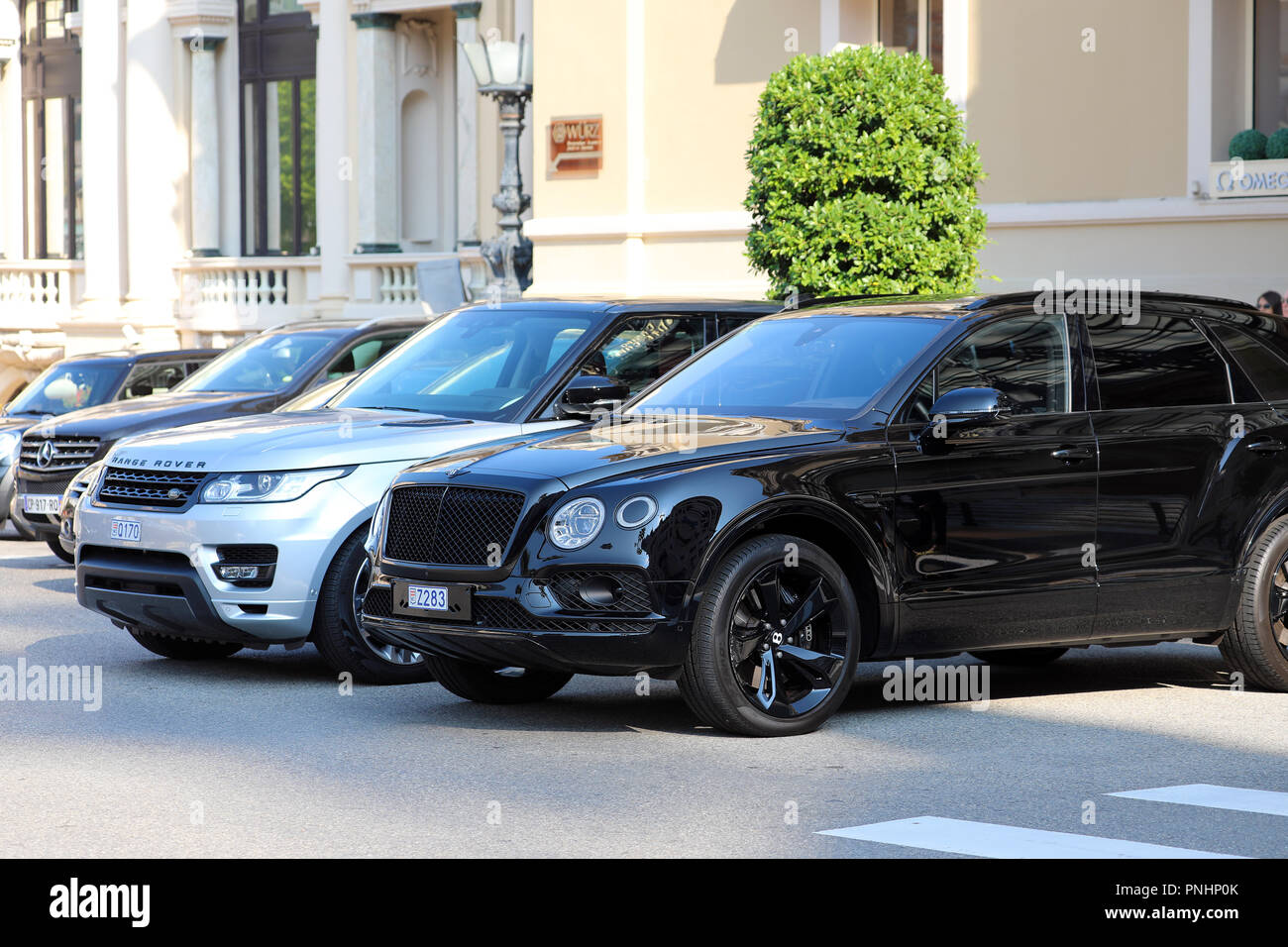 Monte-Carlo, Monaco - September 19 2018 : Two Luxurious SUVs Parked In Front Of Monte Carlo Casino In Monaco : Black Bentley Bentayga And Silver Range Stock Photo