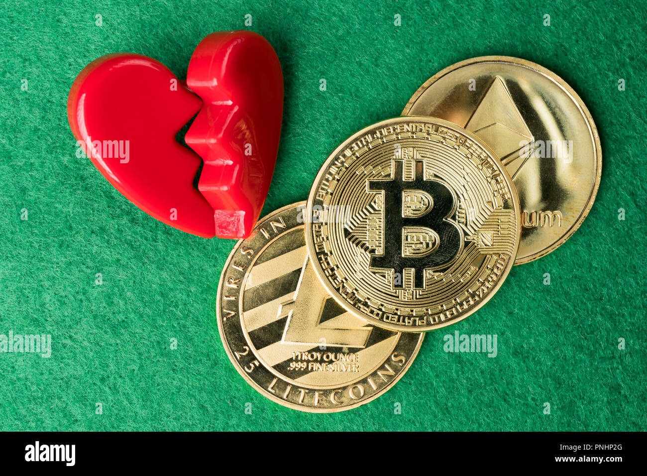 Gold physical Bitcoin, Litecoin and Ethereum coins with broken heart on  green background. Crypto currency market break or no love abstract concept.  Fl Stock Photo - Alamy