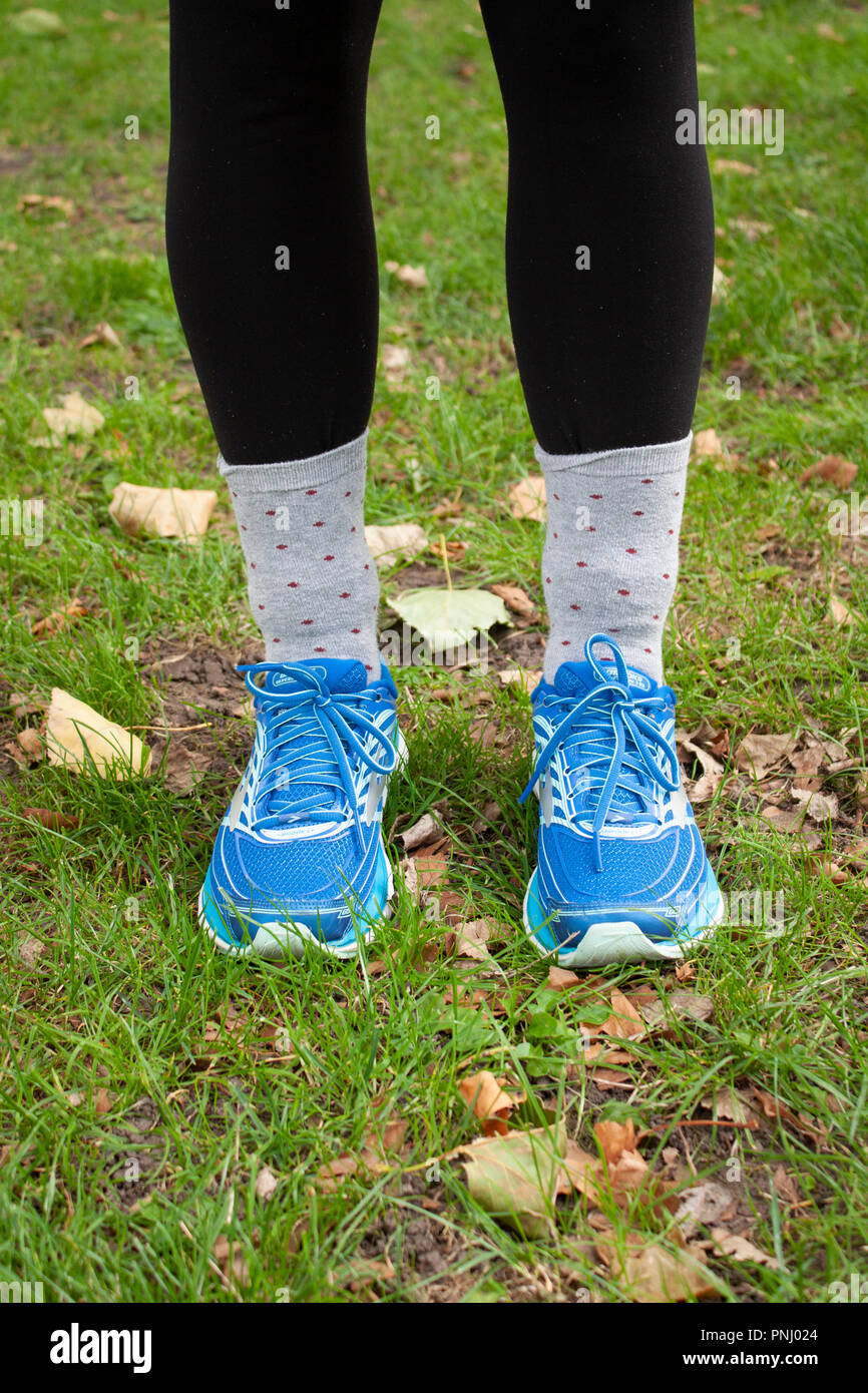 Girl wearing socks over trousers for tick bite prevention, to protect