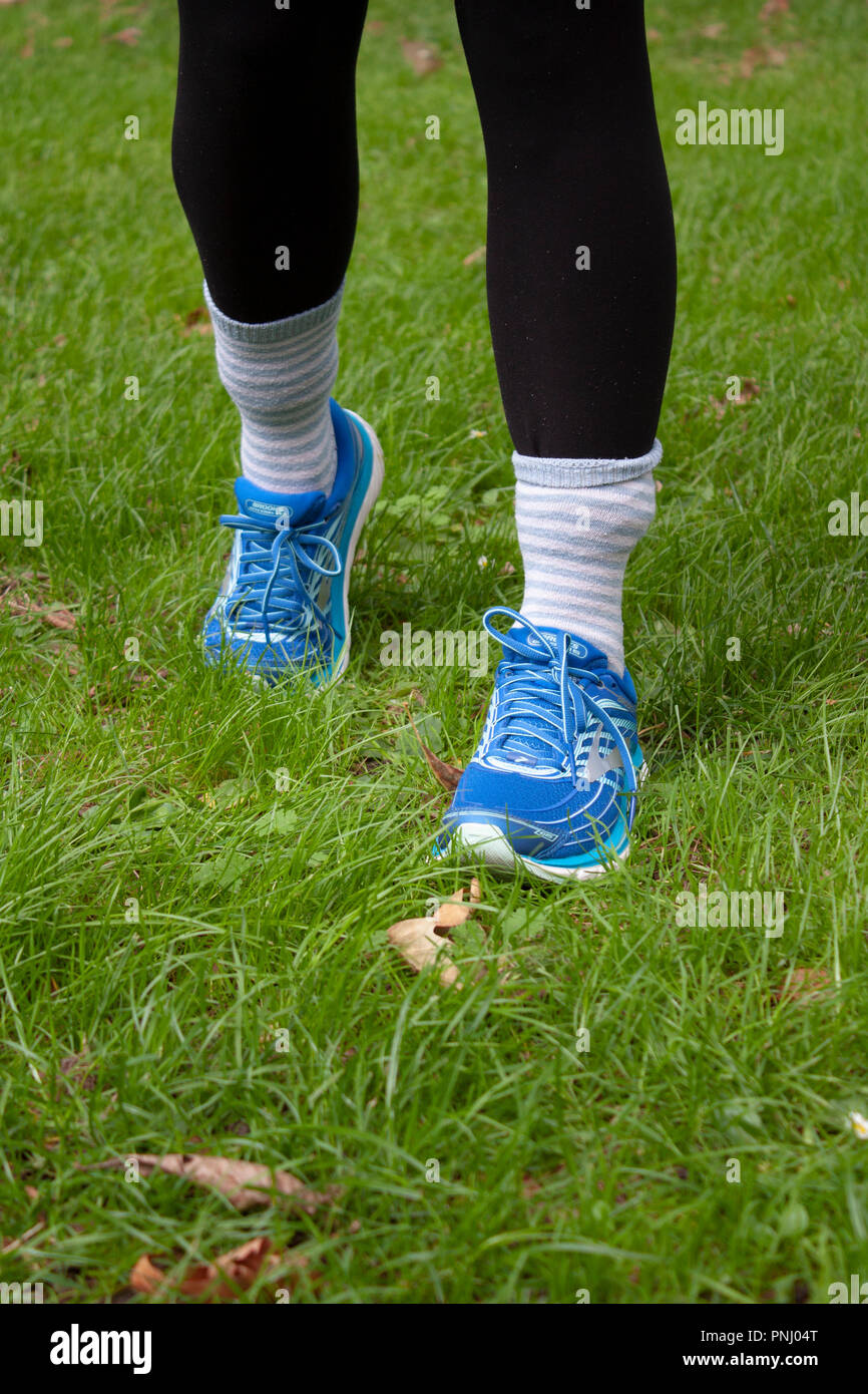 Girl wearing socks over trousers for tick bite prevention, to protect kids from Lyme diseases and other tick borne infections Stock Photo
