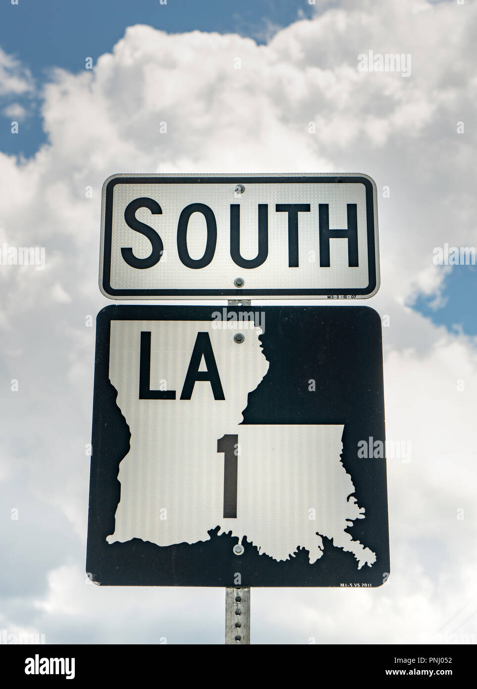 A vertical composition of a Louisiana highway 1 south roadside sign post Stock Photo