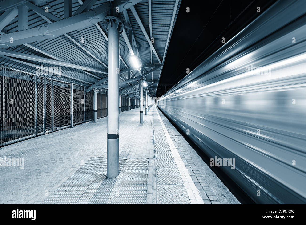 Highspeed train arrives to the station platform at night time Stock ...