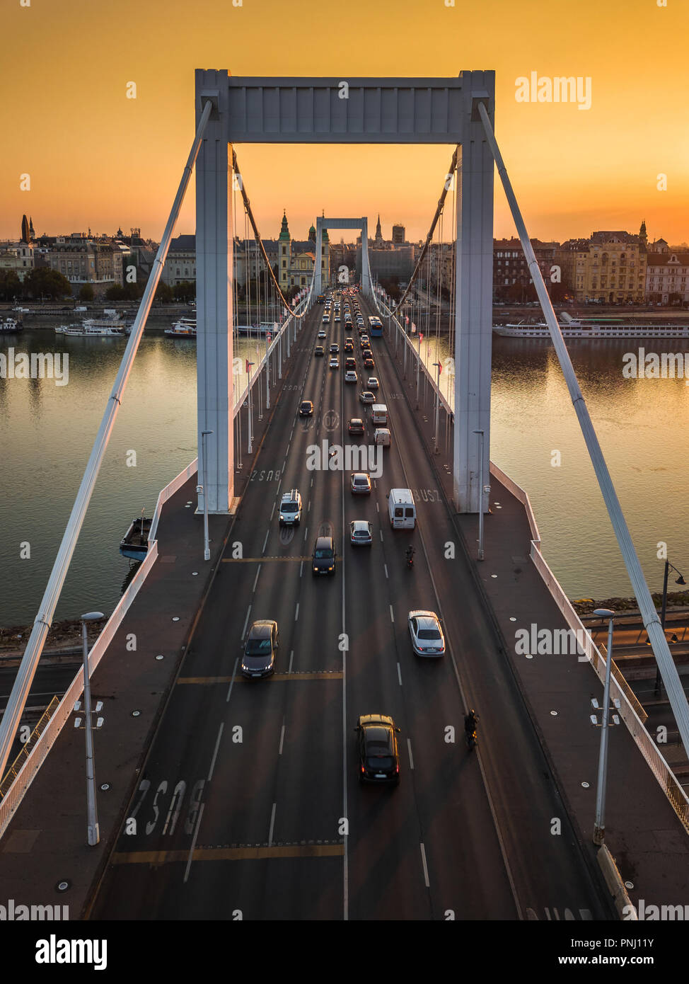 Budapest, Hungary - Beautiful Elisabeth Bridge (Erzsebet hid) at sunrise with golden sky and heavy morning traffic Stock Photo