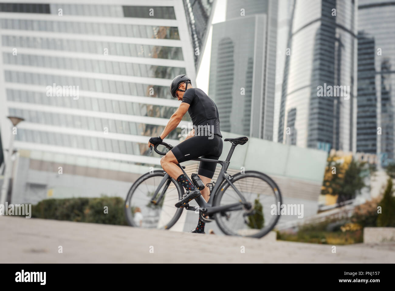 Modern man riding bike hi-res stock photography and images - Alamy
