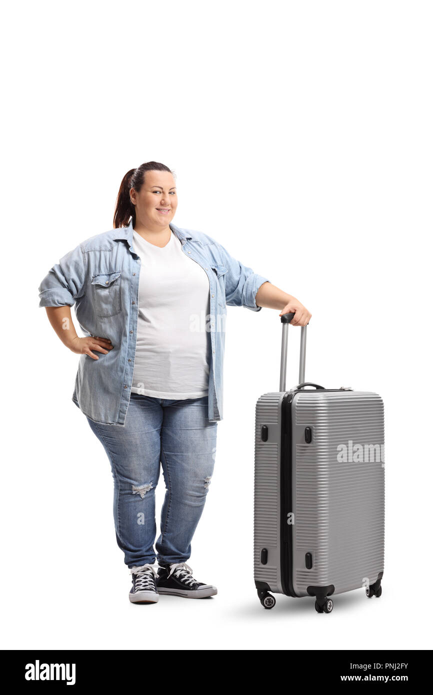 Full length portrait of a chubby young woman with a suitcase isolated on white background Stock Photo