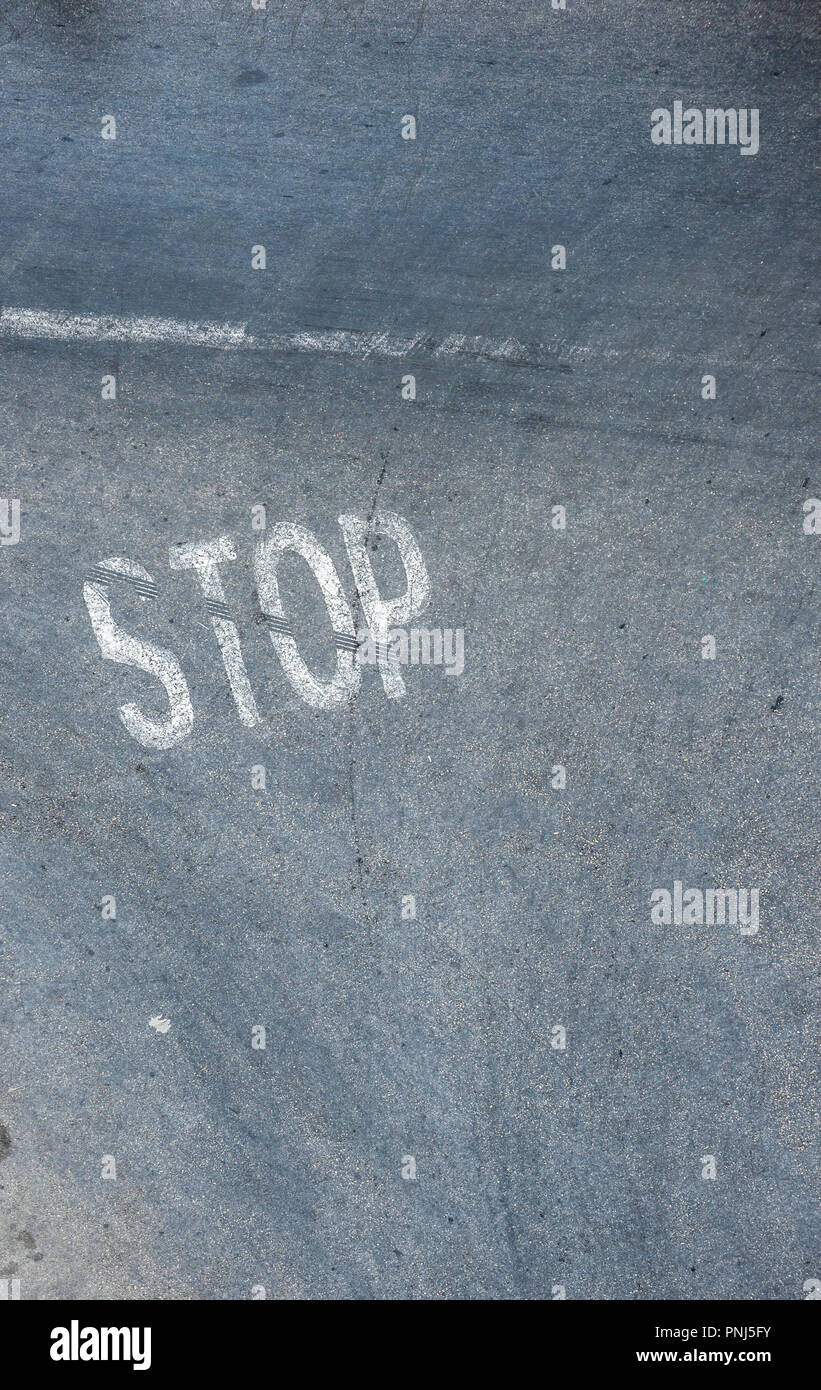 Road sign, STOP, painted onto the road. Stock Photo
