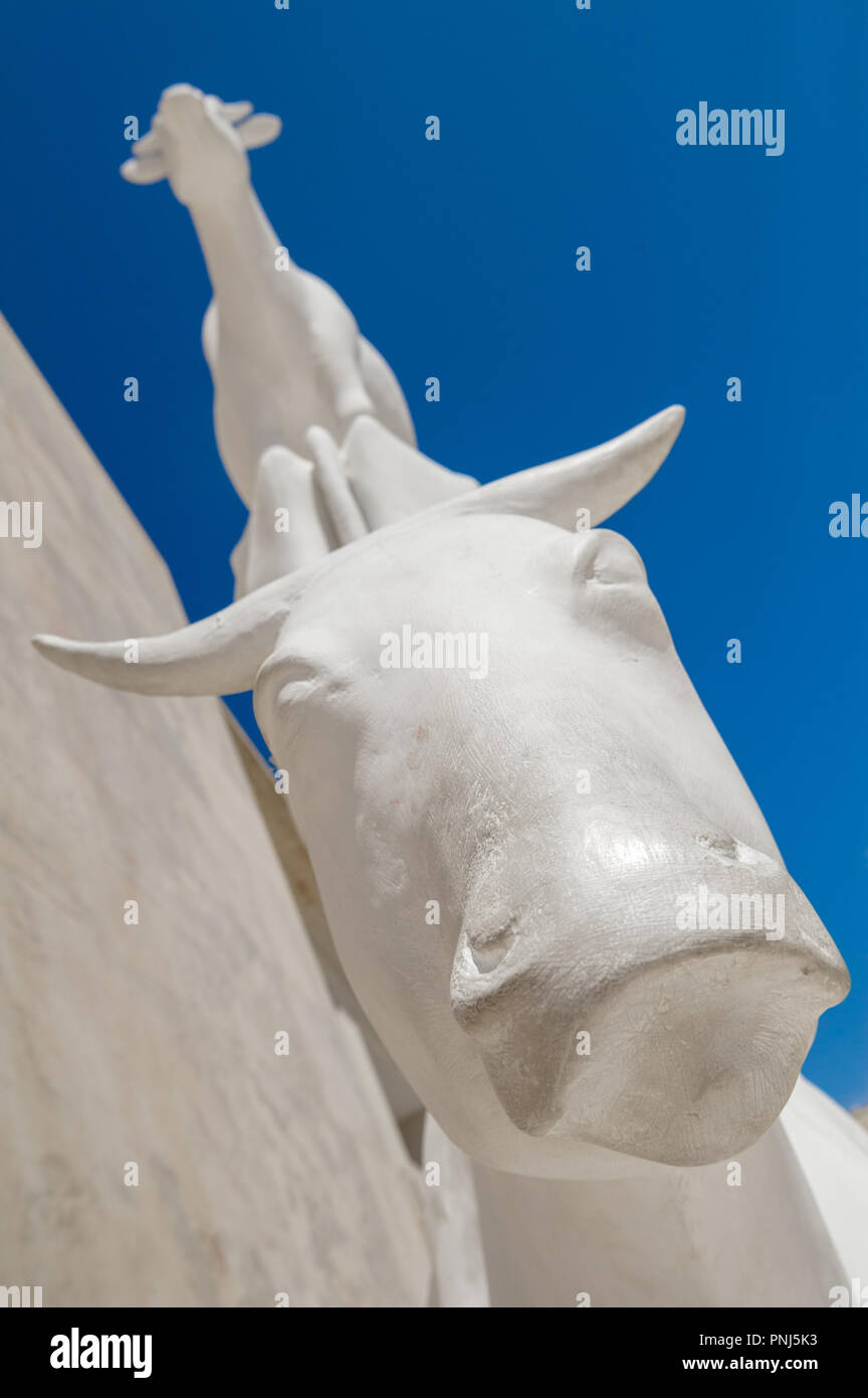 Statue of three white cows standing on each other in castle square, Valletta, Malta. Stock Photo