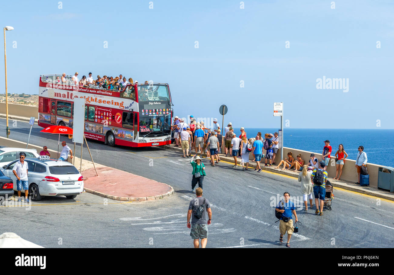 The maltese open top 'hop on hop off' tourist double decker bus at a stop Blue Grotto, Malta. Stock Photo