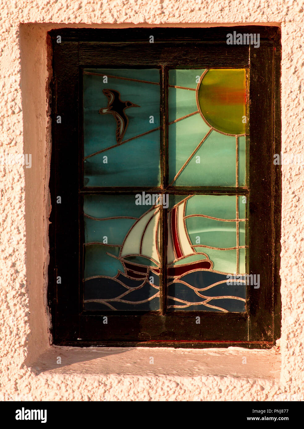 A stained glass window on a house at Portmahomack, Easter Ross, Scotland Stock Photo