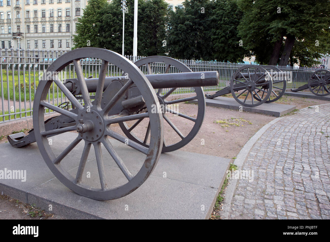 Old single barrel wheeled iron cannons of russian army of 19th century exposed on the city square Stock Photo