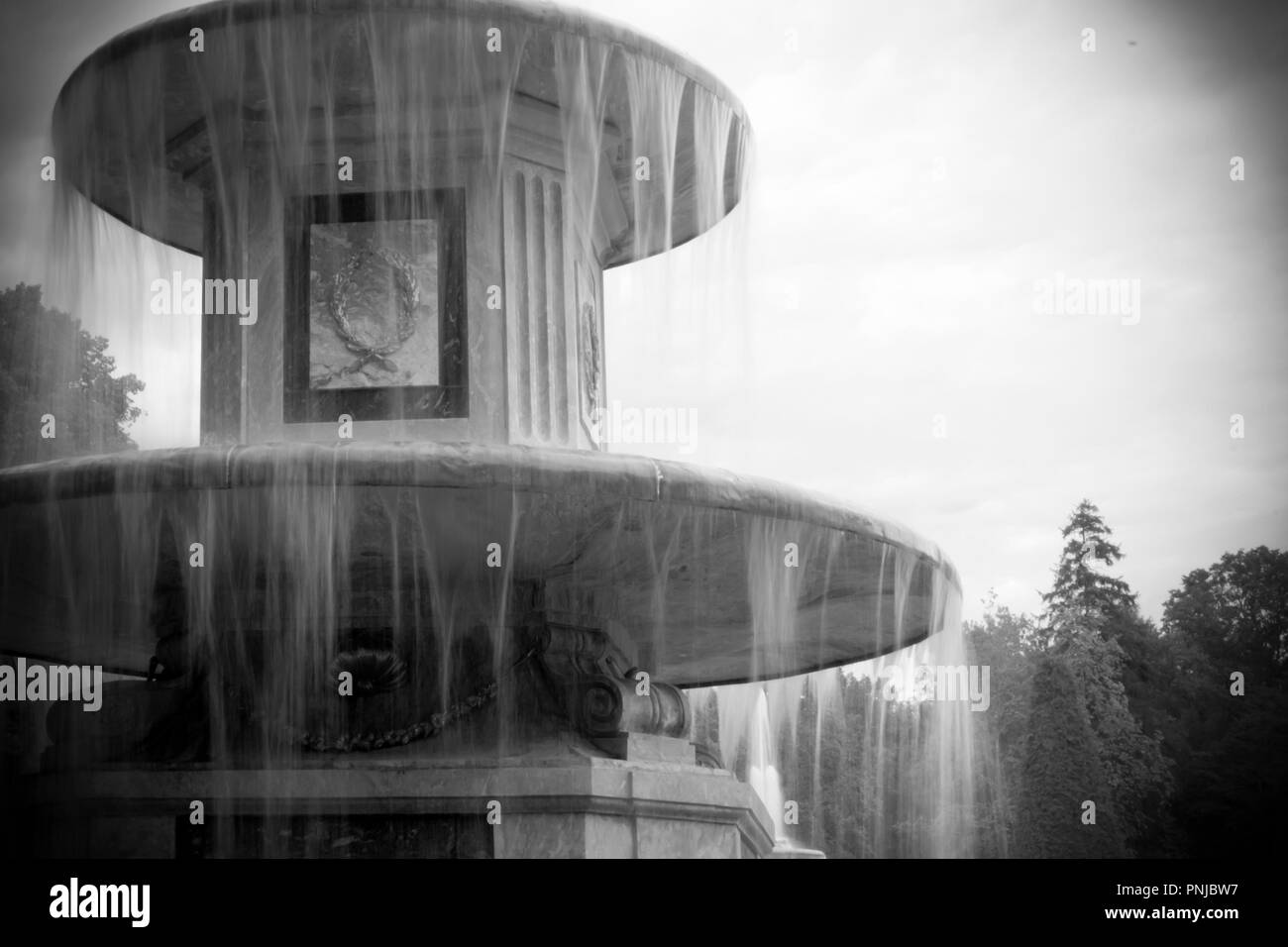 One of the two Roman fountains in Peterhof, Russia. 18th century landmark,  black and white image with darkened vignette Stock Photo