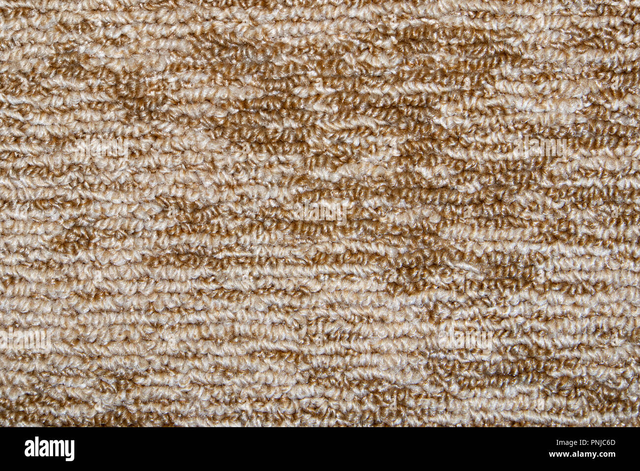 Beige striped synthetic short-napped floor carpet covering, may be used as background or texture Stock Photo