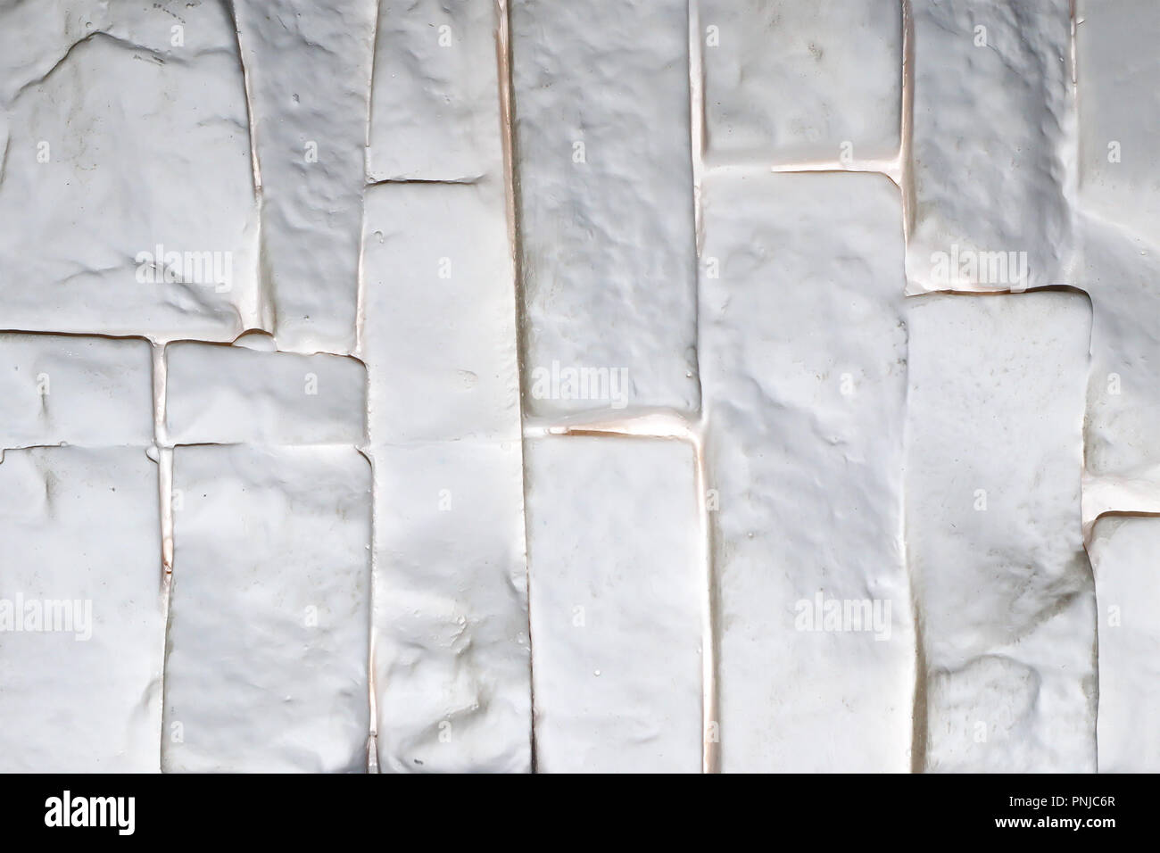 White brick wall plastic panel vertically oriented, may be used as background or texture Stock Photo