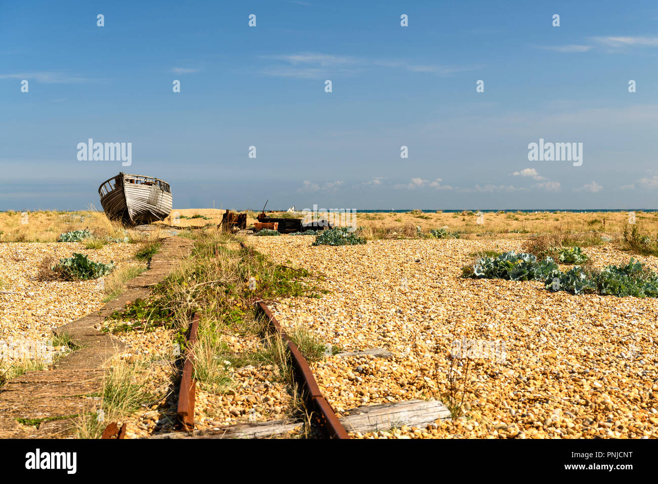 An abandoned fishing boat and trackway on the shingle beach at ...