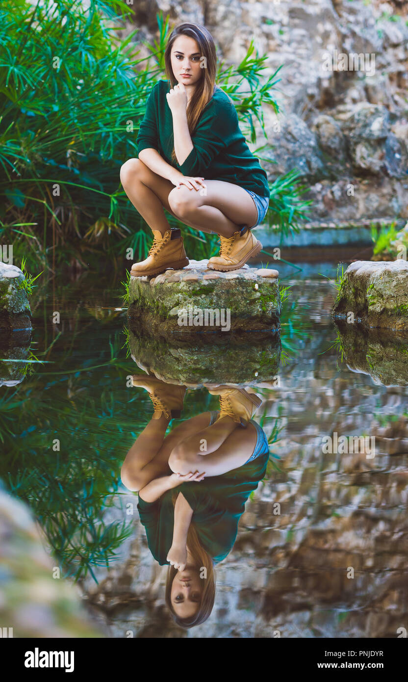 Beautiful young woman posing in lake Stock Photo - Alamy