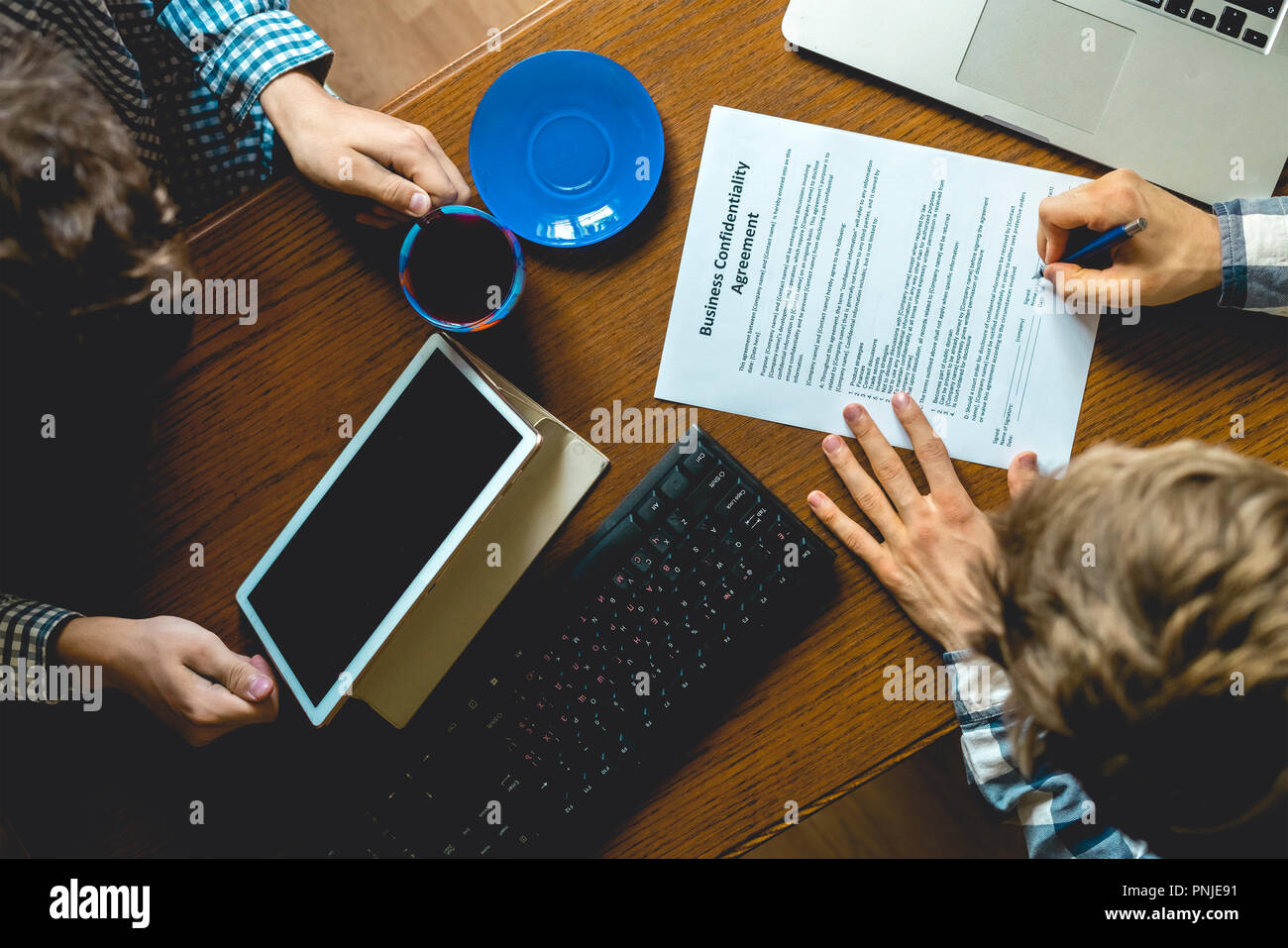 top overhead view of people with agreement documents on office working and signing Stock Photo