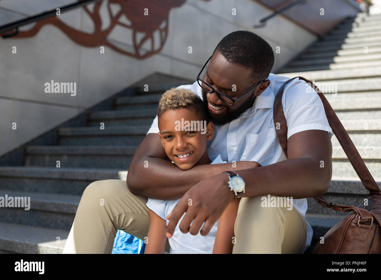 Joyful caring nice father hugging his son Stock Photo