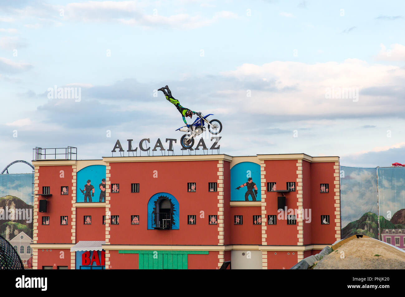 Motorcycles and Bikes jump stunts at Energylandia amusement park in Poland  with the biggest roller coaster in Europe located in Zator in Lesser Poland  Stock Photo - Alamy