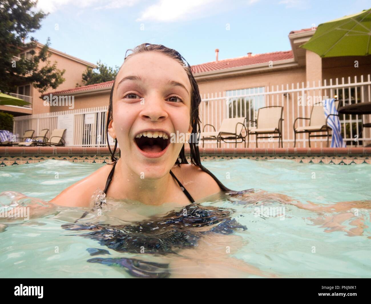 Happy teenager in swimmingpool having fun in the sun Stock Photo Alamy