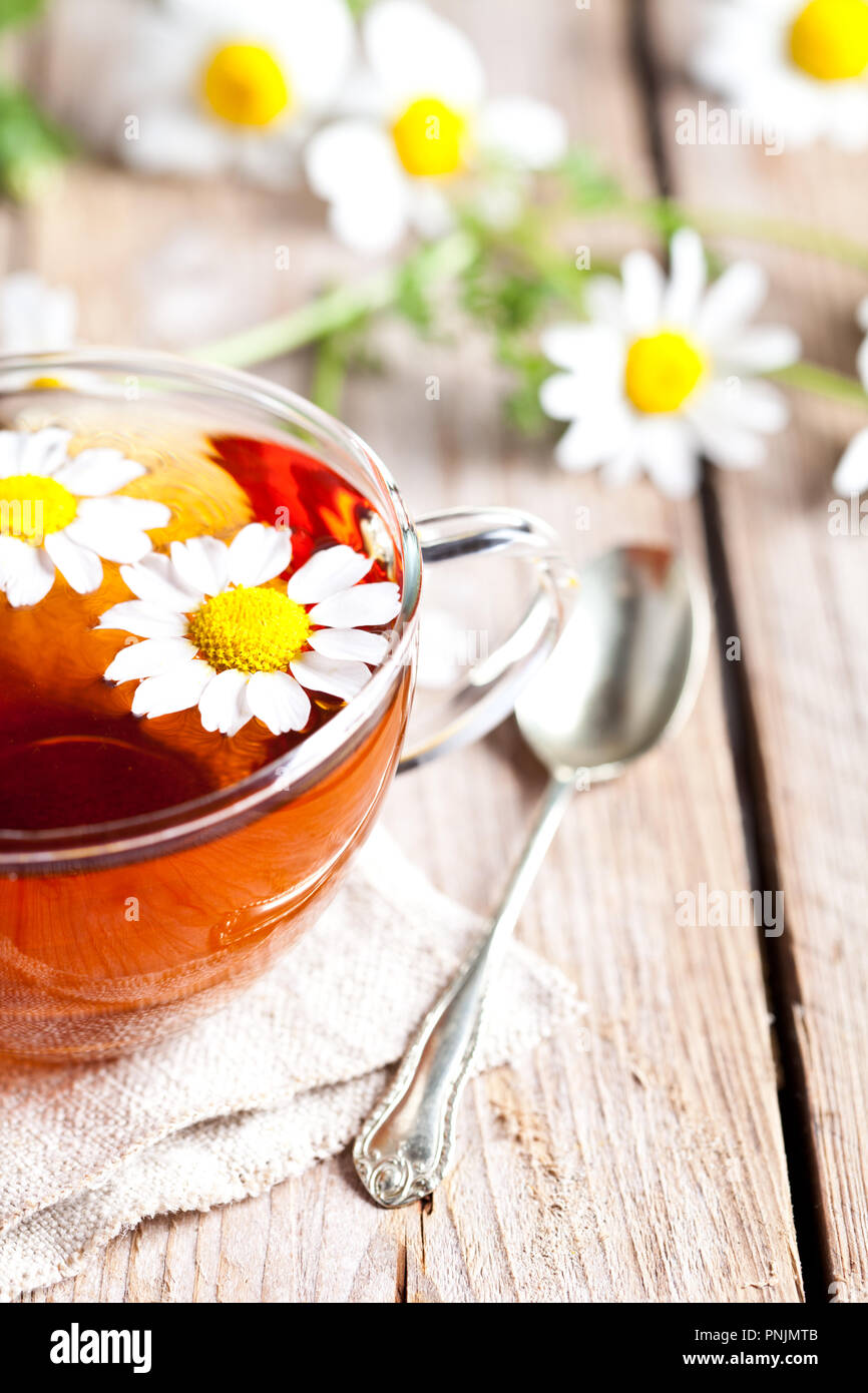 cup of tea with chamomile flowers on rustic wooden background Stock ...