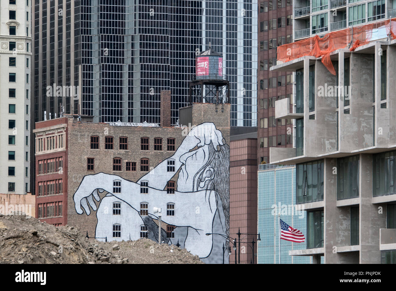 Detail of an old and new building with a large mural and American flag, Downtown Chicago, IL. Stock Photo