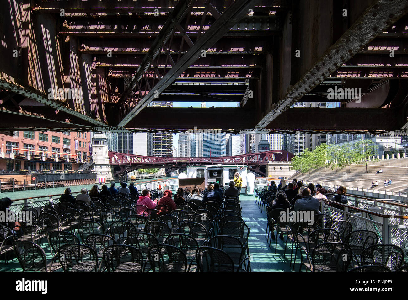 Boat cruise on the Chicago River under a bridge, Downtown Chicago, IL. Stock Photo