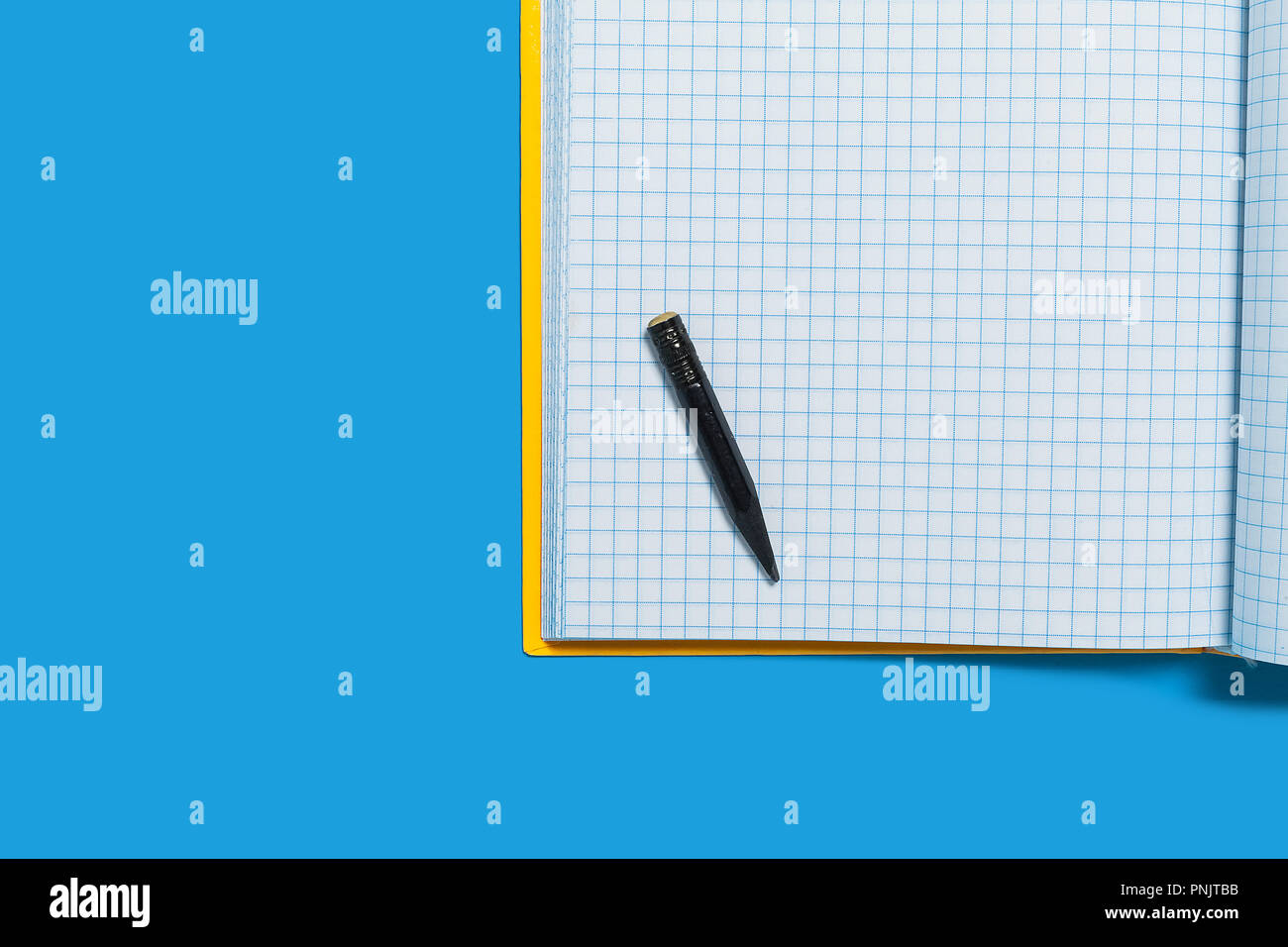 Black used pencil lying on a workbook Stock Photo